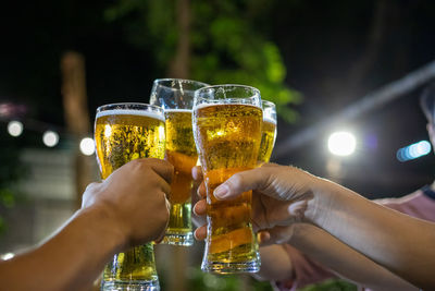 People holding glass of wine