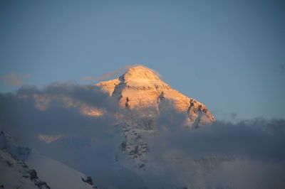Low angle view of snowcapped mountain against sky