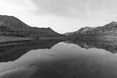 Scenic view of lake and mountains against sky