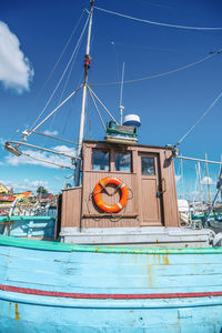 View of ship moored at sea against blue sky