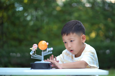 Portrait of boy sitting outdoors