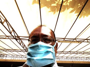 Low angle portrait of man wearing mask