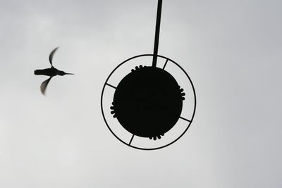 Close-up of silhouette airplane against clear sky