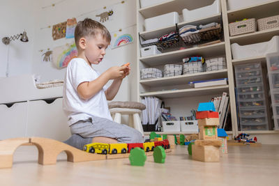 Siblings playing with toy blocks