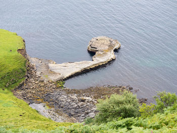 High angle view of rock by sea