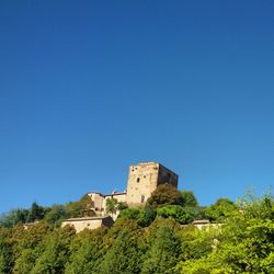 Low angle view of castle against blue sky