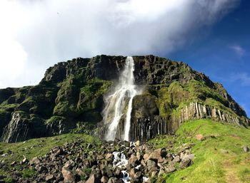 Low angle view of waterfall against sky