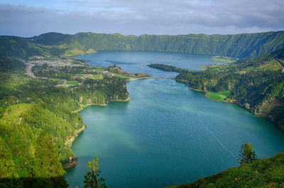 High angle view of river amidst mountains against sky