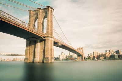 Low angle view of suspension bridge against sky