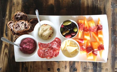 Directly above shot of food arranged in white tray on wooden table