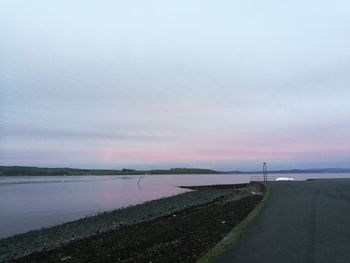 Road by sea against sky