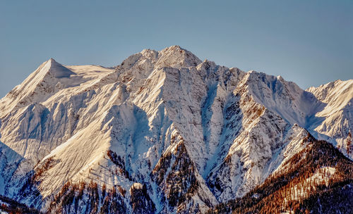 Panoramic view of snowcapped mountains against clear sky