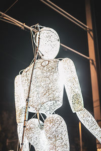 Low angle view of decoration hanging on metal structure