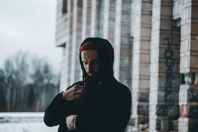 Man looking at camera in city