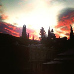 Buildings against sky at sunset