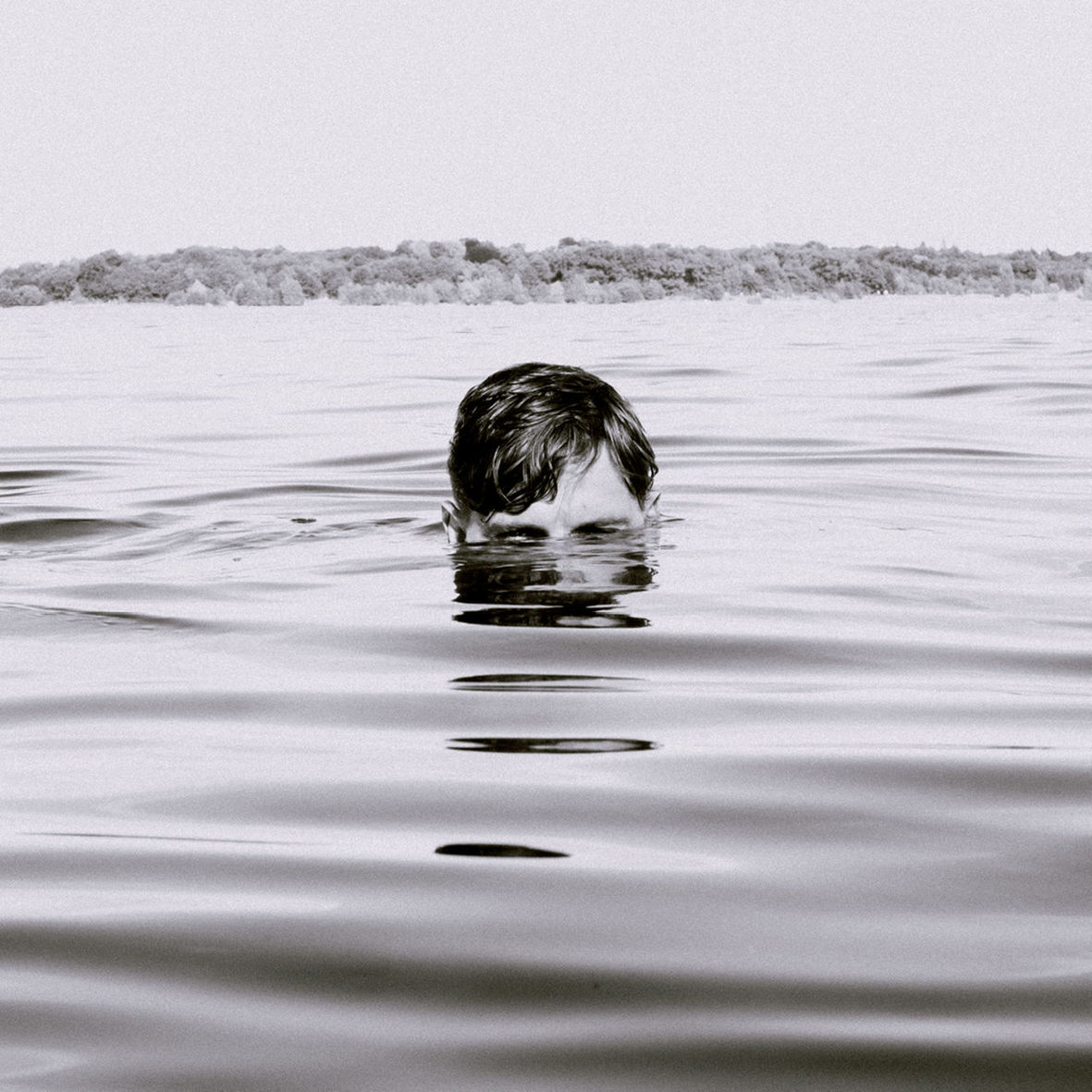 water, one person, swimming, headshot, leisure activity, real people, nature, childhood, waterfront, rippled, outdoors, shirtless, lifestyles, day, sea, swimming pool, boys, clear sky, sky, mammal, people