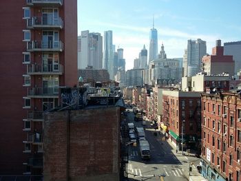 High angle view of vehicles on road along buildings