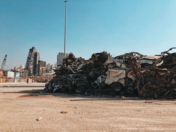 Stack of destroyed cars from beirut explosion against clear blue sky