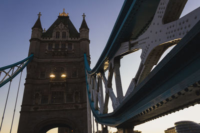 Low angle view of bridge and buildings against sky