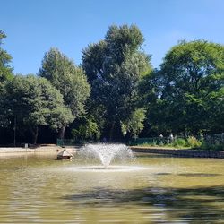 Water splashing in fountain against sky