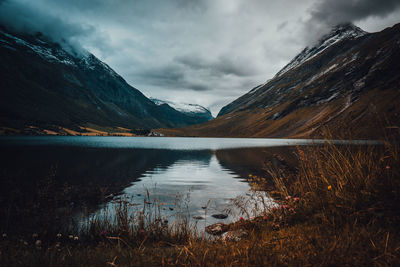 Scenic view of lake and mountains against sky