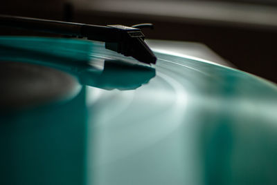 Close-up of turquoise record playing in turntable