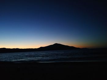 Scenic view of sea against clear sky during sunset