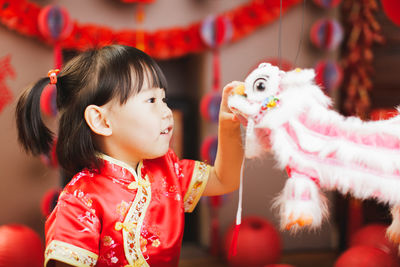 Cute girl looking at toys