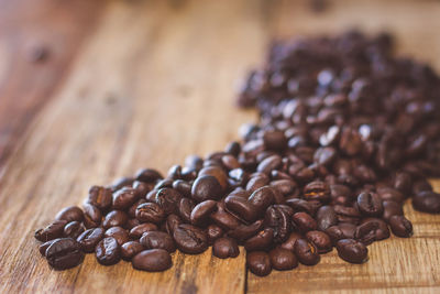 Close-up of roasted coffee beans on table