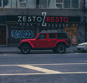 Red road sign on street in city