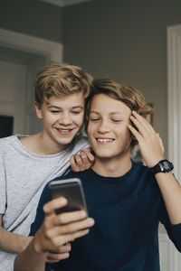 Portrait of teenage boy using mobile phone