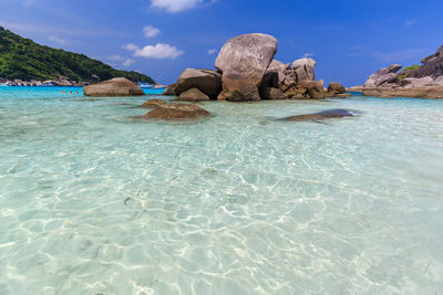 Rocks on beach against sky