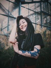 Portrait of smiling young woman standing outdoors