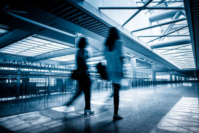 Blurred motion of people walking in airport