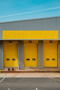 Yellow industrial buildings against blue sky 