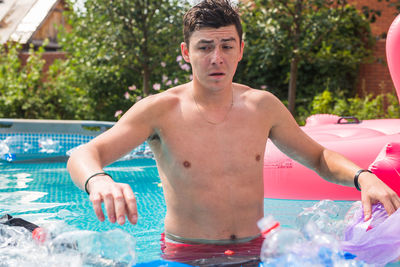 Portrait of shirtless boy in swimming pool