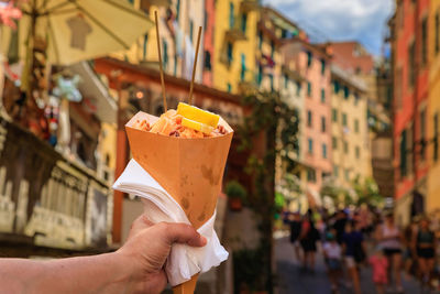 Cropped hand holding ice cream cone