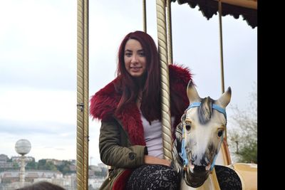 Portrait of young woman enjoying carousel