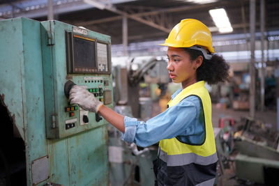 Side view of man working in factory