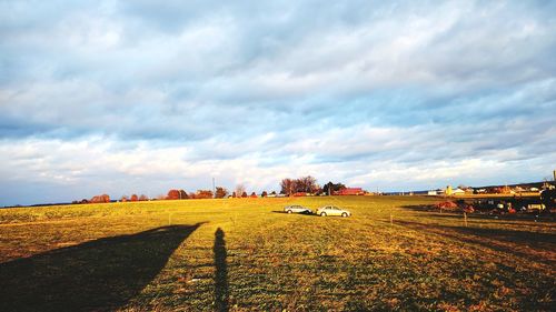 Scenic view of agricultural field against dramatic sky