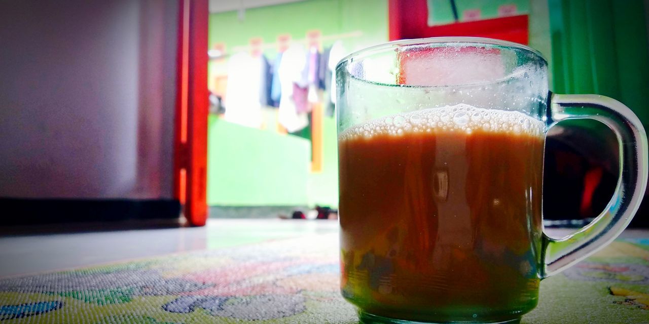 CLOSE-UP OF BEER ON GLASS TABLE