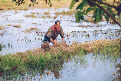 Full length of young man at lakeshore