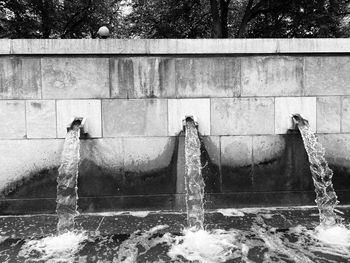 Water splashing on fountain against wall