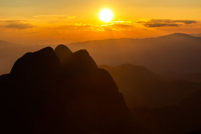 Scenic view of silhouette mountains against sky during sunset