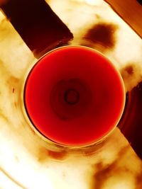 High angle view of red wine in glass on table