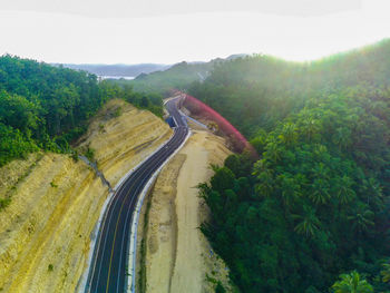 Road amidst trees against sky