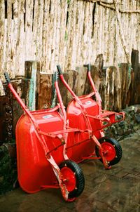 Close-up of abandoned cart against trees