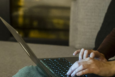 Midsection of woman using laptop