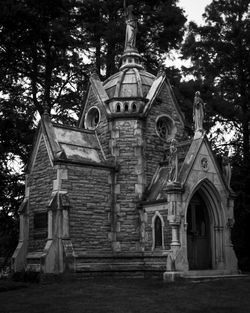 Low angle view of old building against trees