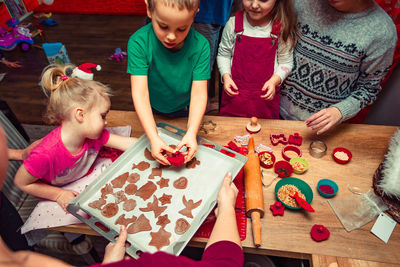 High angle view of children making cookies